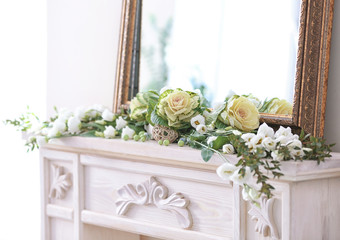 Beautiful composition with fresh flowers on mantelpiece