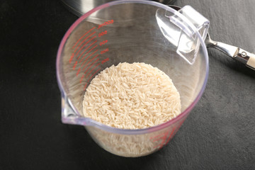 Rice in measure glass on kitchen table