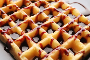 Delicious wafer cells with chocolate syrup, closeup