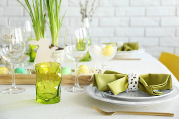 Beautiful Easter table setting with green glasses