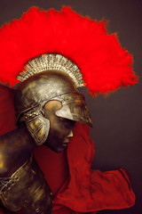 Studio shot of mannequin in armor and in helmet with feathers