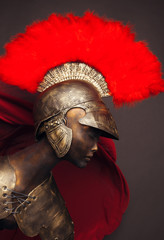 Studio shot of mannequin in armor and in helmet with feathers