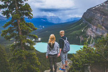 Couple on the top of the mountains looking at Lake Louise