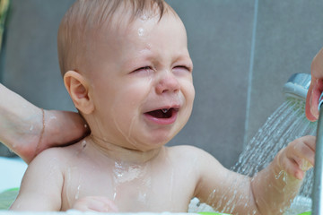 Mother washing baby