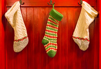 Three Stockings Hanging on Hooks