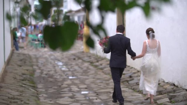 Married Couple walking in streets in Paraty, Rio de Janeiro, Brazil