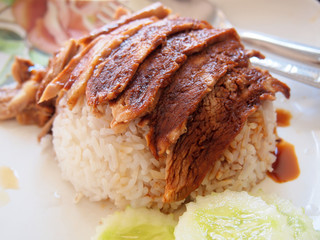 Fried sliced pork with garlic with rice and cucumber