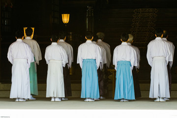 Japanese priests in robes performing morning service