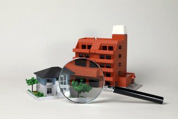 miniature models of residence and magnifying glass