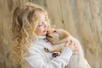 Little girl with a labrador puppy