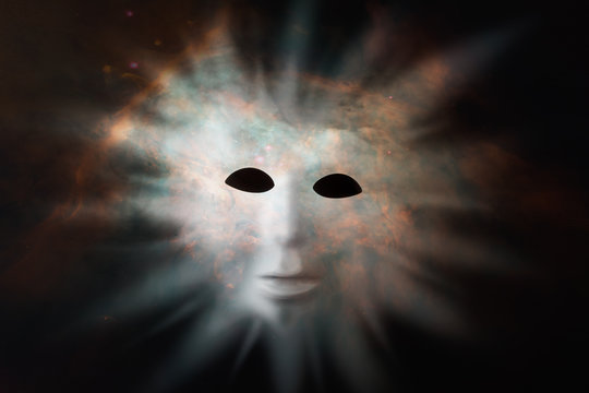 Human face mask protruding through fabric of space - extraterrestrial life discovery concept. Elements of this image were furnished by NASA
