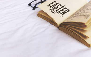 easter story book on bed with soft-focus in the background. over light