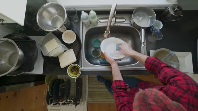 Timelapse of a man washing dishes