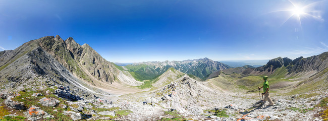 Spherical panorama 360 to 180 The man stands on top in the mountains