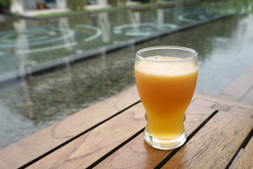 Glass of mixed fruit smoothy on timber table