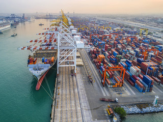 commercial vessel container ship alongside of berth in port congestion for loading and discharging  containers services in maritime transports in World wide logistics