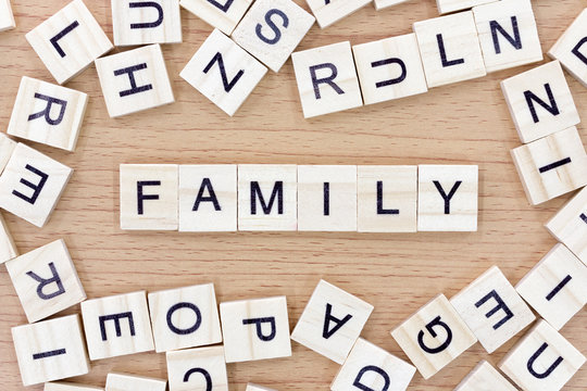 Family words with wooden blocks on wooden floor