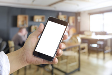 Businessman holding blank screen smart phone in cafe.