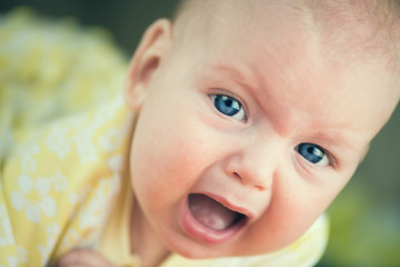 Portrait of crying baby girl.