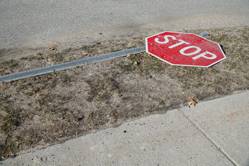 stop sign fallen on the road side
