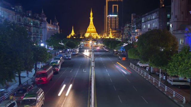 Timelapse of Golden Buddhist Pagoda and Temple at Night With Busy Road
