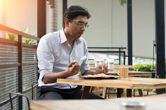 asian business man having roti canai outdoor