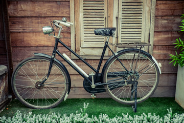 Fototapeta na wymiar Old bicycle on vintage wooden floor