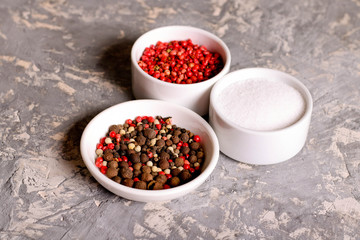 Fototapeta na wymiar assortment of pepper and salt in bowls, closeup, horizontal