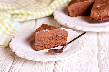 Dark chocolate layer cake on white plate