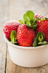 Ripe red strawberries on wooden table