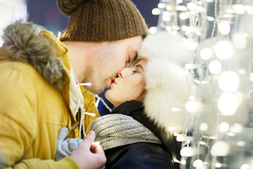 Kissing couple hugging background town