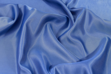 Fototapeta premium Silk background, texture of blue shiny fabric, close up