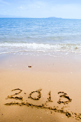 Numbers 2013 on beach - concept holiday background