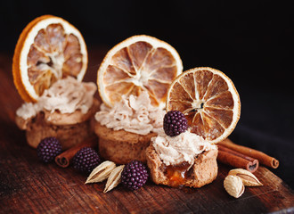 Fototapeta na wymiar almond and orange cupcake with fresh blackberry