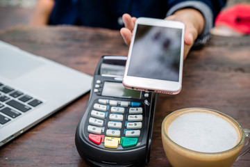 Online payment,hand using phone on worktable