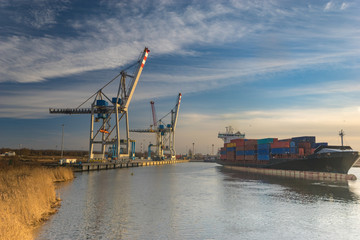 Szczecin ,Poland-January 2017:sea container flows into port for unloading harbor cranes and gantries