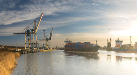 Fototapeta premium Szczecin ,Poland-January 2017:sea container flows into port for unloading harbor cranes and gantries