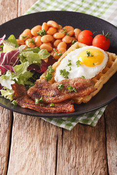 Healthy breakfast: waffle sandwich with egg, bacon, beans and salad close-up. Vertical