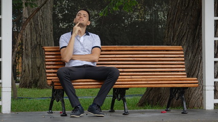 Fototapeta premium Man Sitting Alone In Park And Daydreaming