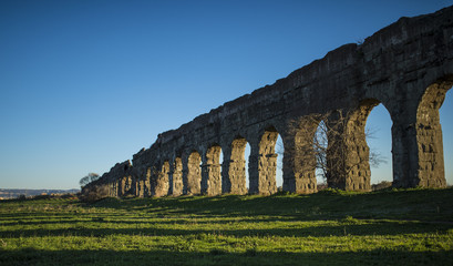 Fototapeta na wymiar Roman aqueduct in Rome at sunset