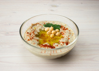 A bowl of creamy hummus with olive oil.
