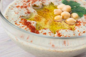 closeup of A bowl of creamy hummus with olive oil.