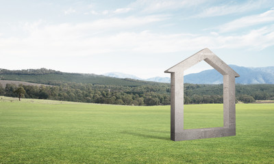 Conceptual background image of concrete home sign on green grass