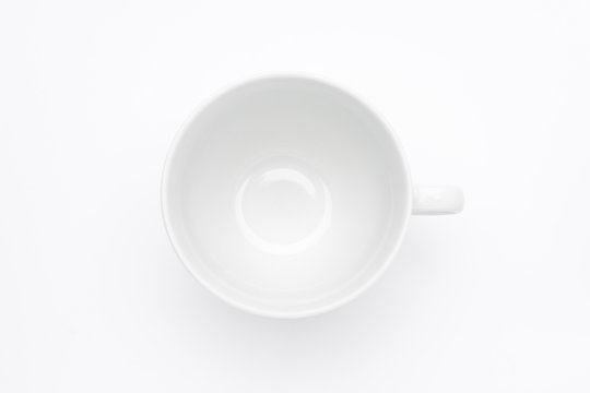 Empty white cup on white background