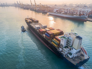 commercial vessel container ship in proceeding arrival to the port channel due, assist by the tugs...