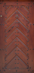 The vintage brown  wooden front door of an old house