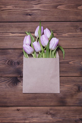 Pink tulips on wooden background