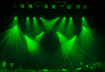 The green light from the spotlights through the smoke in the theatre during the performance....