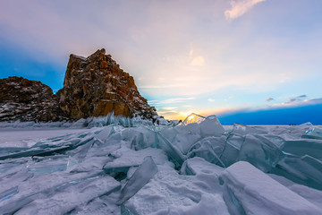 The ice of Lake Baikal at the rock Shamanka, illuminated by the setting sun