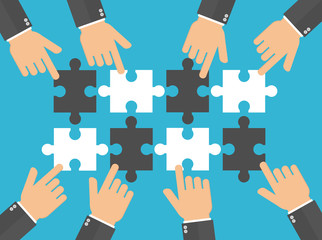 Hands pushing or putting puzzle pieces together. Teamwork concept. Hands pointing to puzzle pieces. Flat design